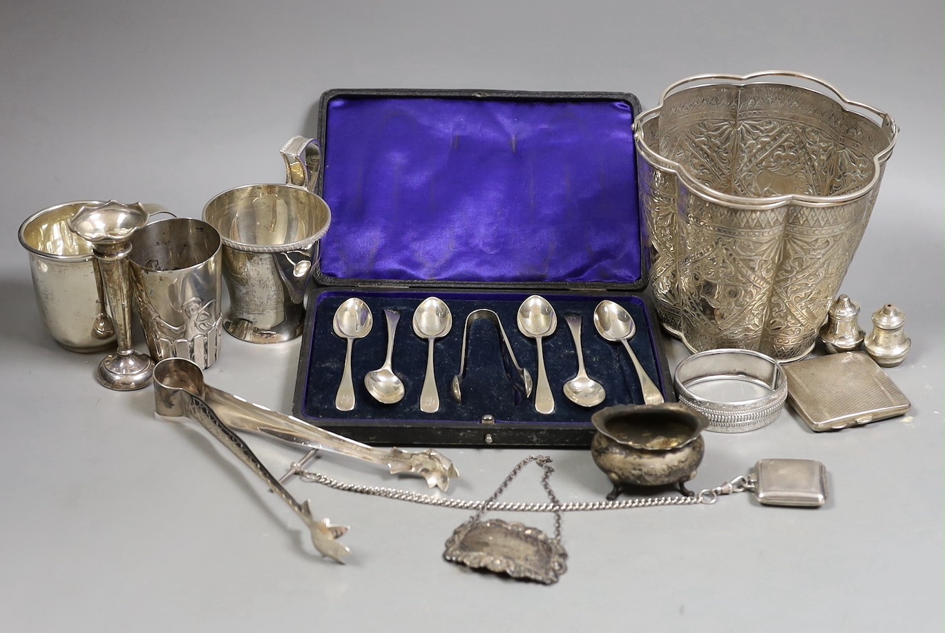 A Siamese sterling two handled ice pail with tongs, height 12.5cm, together with a cased set of six teaspoons with tongs, a silver compact a silver Vogel travelling timepiece on albert chain, three silver condiments, two